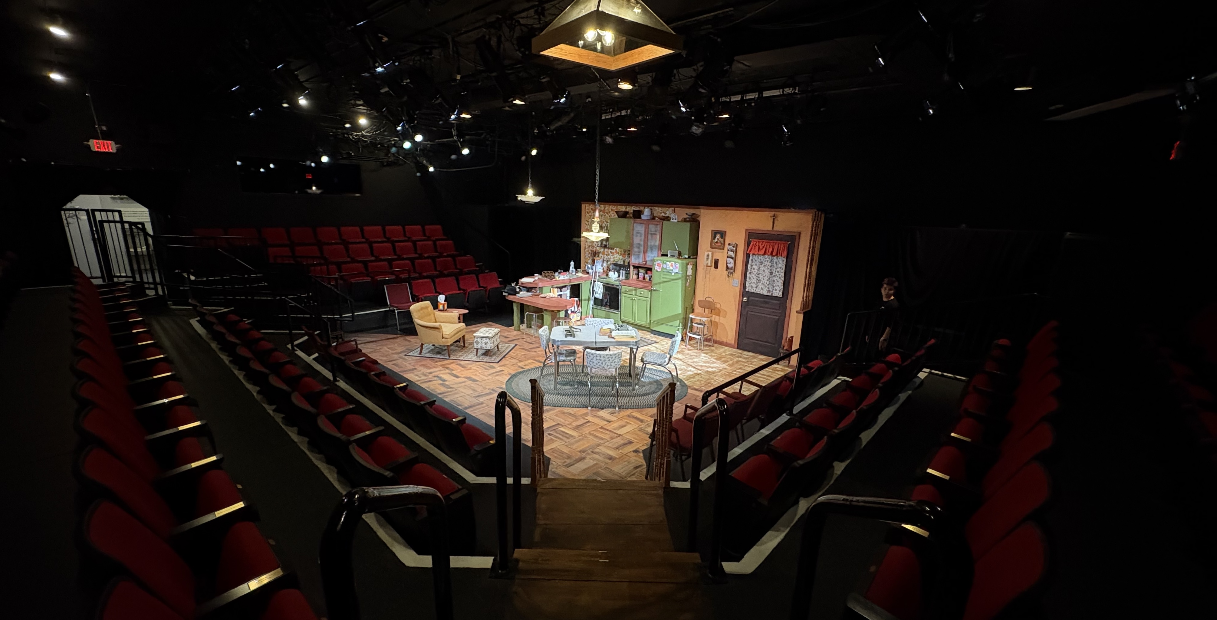 Picture of a theatre set, with a 1970s era kitchen.