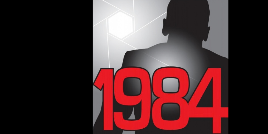 A shadowed figure in a spotlight behind the title 1984.