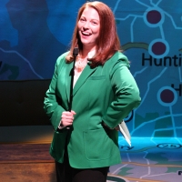 A woman in a green jacket smiling