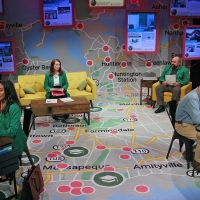 Four people sitting on chairs on a stage