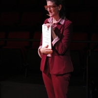 A woman holding a piece of paper.