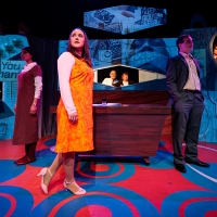 A group of people on a stage, the woman at the front looking into the light of the distance