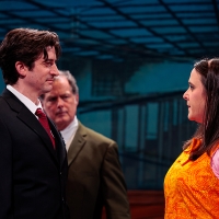 A man and a woman confronting one another, another man looks on