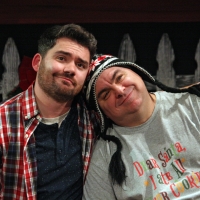 A man leaning his head on another man's shoulder