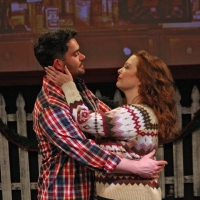A woman with her hands on a man's cheeks, embracing