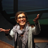 Picture of a woman reaching out to the camera with a smile on her face