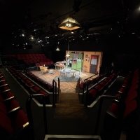 Photo of a set in a theatre with seating on three sides