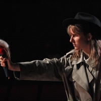 Young girl wearing an old fashioned hat and holding a barbie doll