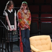Two young women standing next to each other looking guilty