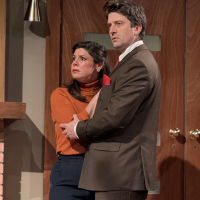 A man holding a woman, both looking frightened