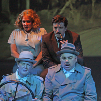 Four people in a car looking forward skeptically