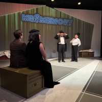 Two people watching a show of Mr. Memory