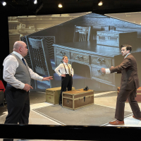 Two men preparing to fight as a third looks on