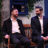 Two men with beards sitting on a bench