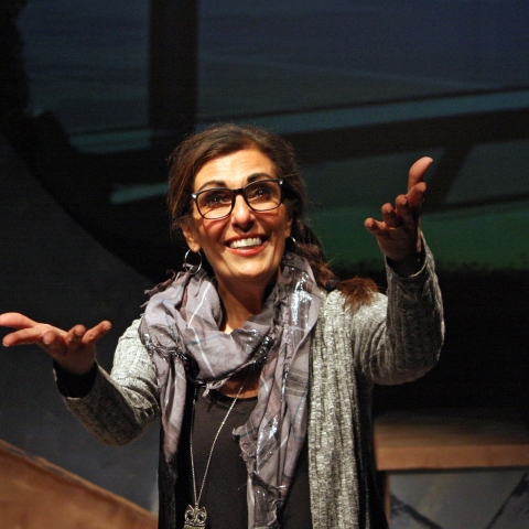 Picture of a woman reaching out to the camera with a smile on her face