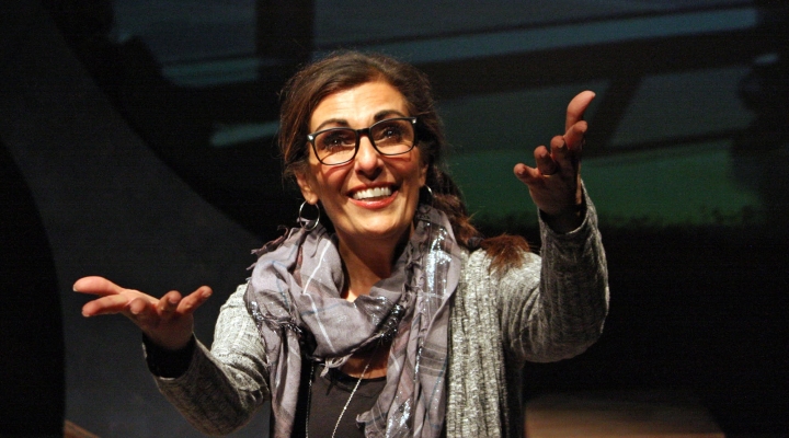 Picture of a woman reaching out to the camera with a smile on her face